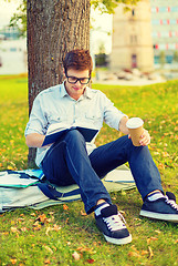 Image showing teenager reading book with take away coffee