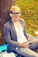 Image showing smiling male student in eyeglasses with tablet pc