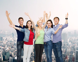 Image showing group of smiling students waving hands