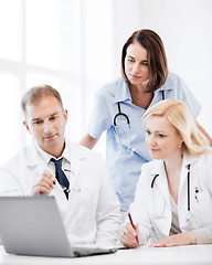 Image showing doctors looking at laptop on meeting
