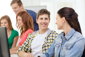 Image showing smiling students in computer class at school