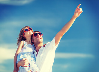 Image showing happy father and child in sunglasses over blue sky