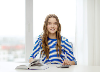 Image showing student girl with book, calculator and notebook