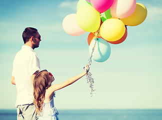 Image showing father and daughter with colorful balloons