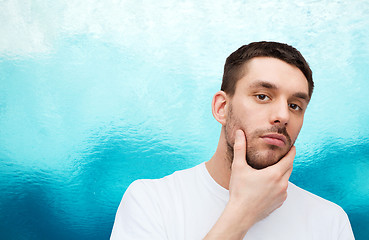 Image showing beautiful calm man touching his face