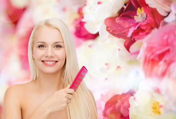 Image showing smiling woman with hair brush