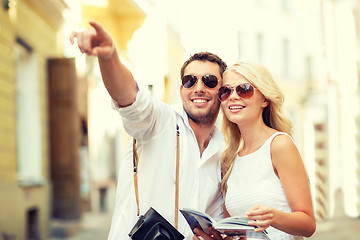 Image showing couple with map, camera and travellers guide