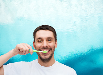 Image showing smiling young man with toothbrush