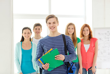 Image showing smiling students with teenage boy in front