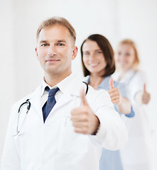 Image showing doctor with stethoscope and colleagues