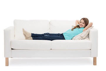 Image showing smiling little girl lying on sofa