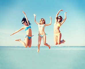 Image showing girls jumping on the beach