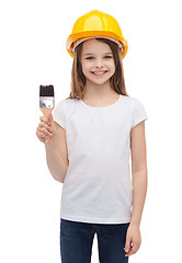 Image showing smiling little girl in helmet with paint roller