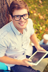 Image showing smiling male student in eyeglasses with tablet pc