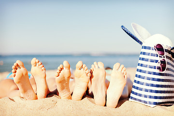 Image showing three women lying on the beach