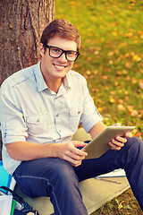 Image showing smiling male student in eyeglasses with tablet pc