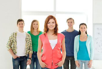 Image showing smiling students with teenage girl in front