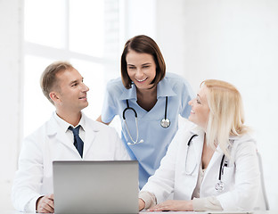 Image showing group of doctors looking at tablet pc