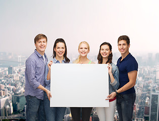 Image showing group of standing students with blank white board