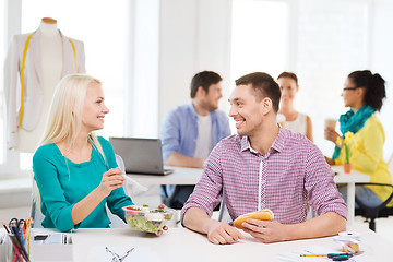 Image showing smiling fashion designers having lunch at office