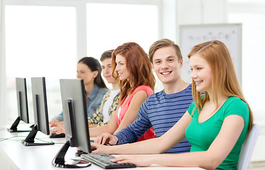 Image showing smiling student with computer studying at school