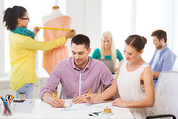 Image showing smiling fashion designers working in office