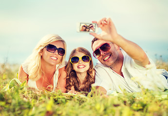 Image showing happy family with camera taking picture