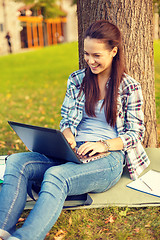 Image showing smiling teenager with laptop
