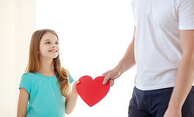 Image showing smiling little girl and father holding red heart