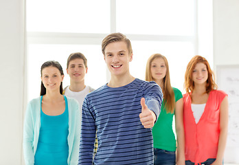 Image showing smiling students with teenage boy in front