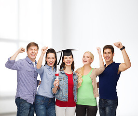 Image showing group of standing smiling students with diploma