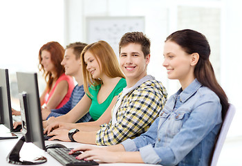 Image showing smiling student with computer studying at school