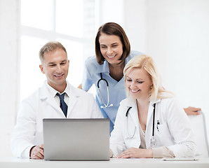 Image showing group of doctors looking at tablet pc