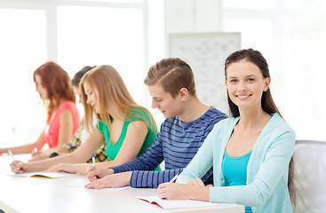 Image showing smiling students with textbooks at school