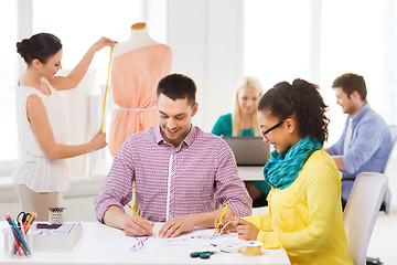 Image showing smiling fashion designers working in office