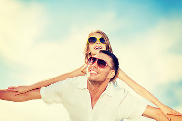 Image showing happy father and child in sunglasses over blue sky