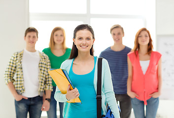 Image showing smiling students with teenage girl in front