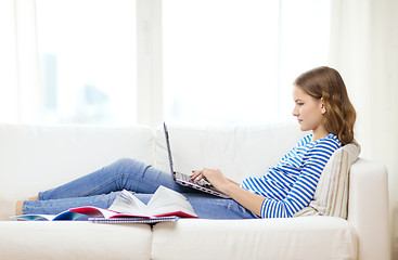 Image showing busy teenage girl with laptop computer at home