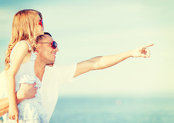 Image showing happy father and child in sunglasses over blue sky