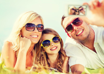 Image showing happy family with camera taking picture