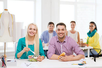 Image showing smiling fashion designers having lunch at office