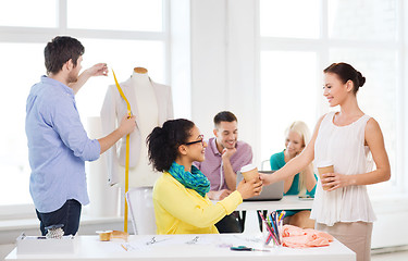 Image showing smiling fashion designers working in office