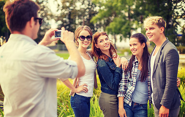 Image showing teenagers taking photo with digital camera outside