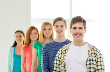 Image showing smiling students with teenage boy in front