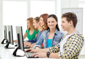 Image showing smiling student with computer studying at school