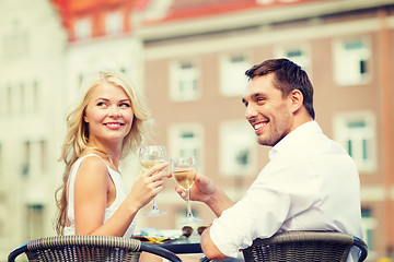 Image showing smiling couple drinking wine in cafe