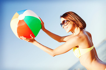 Image showing girl in bikini playing ball on the beach