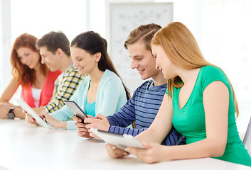 Image showing smiling students with tablet pc at school