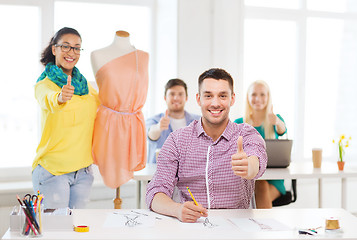 Image showing smiling fashion designers working in office