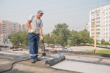 Image showing Worker make waterproofing of seams on bridge